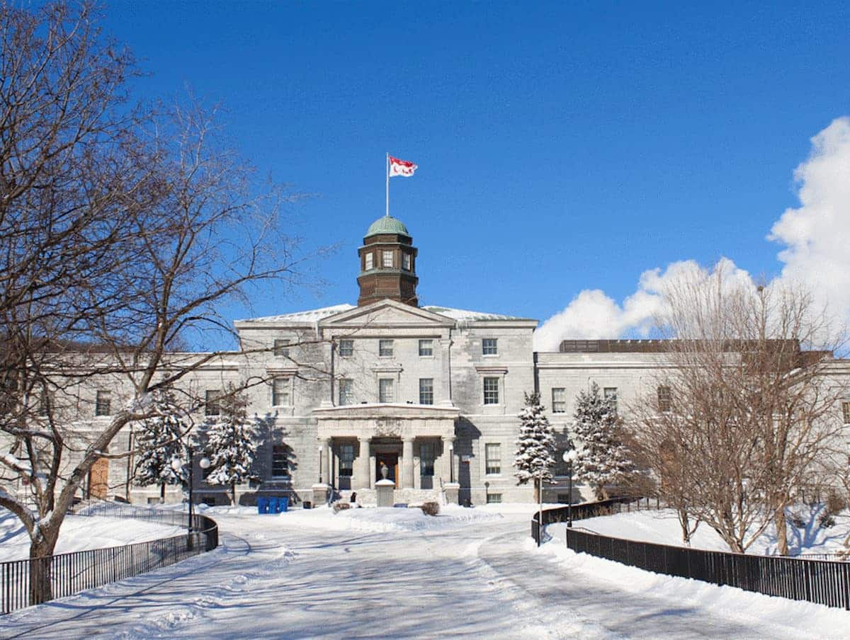 PhD in Canada guide showing a Canadian research university campus, covering admissions, funding, and doctoral study